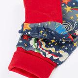 Close up of the red fold up leg cuffs on the Frugi parsnip organic cotton dungaree in navy with an all over explore the stars print.