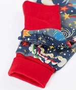 Close up of the red fold up leg cuffs on the Frugi parsnip organic cotton dungaree in navy with an all over explore the stars print.