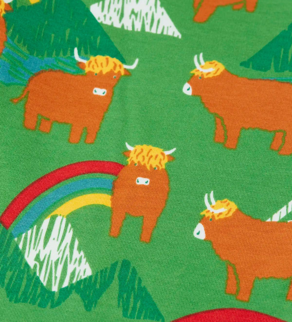 Close up of the cows on the Frugi parsnip joggers in palm green with highland coos cow print. 