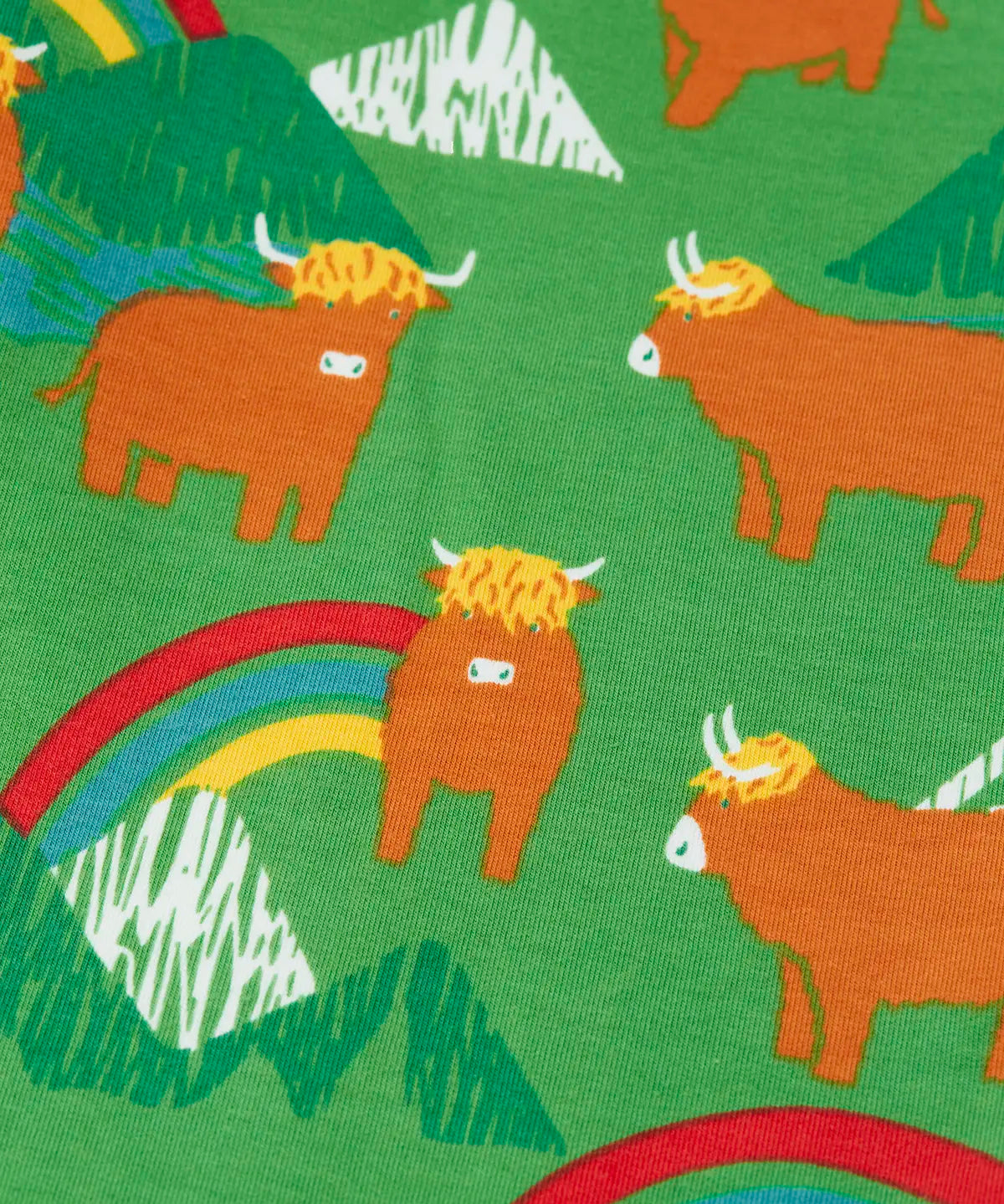 Close up of the cows on the Frugi parsnip joggers in palm green with highland coos cow print. 