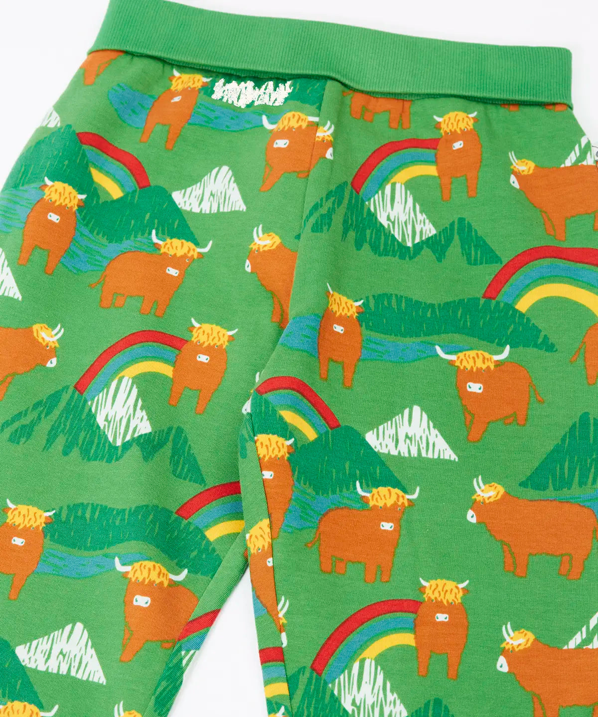 Close up of the Frugi parsnip joggers in palm green with highland coos cow print. 