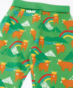 Close up of the Frugi parsnip joggers in palm green with highland coos cow print. 
