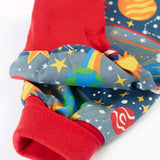 Frugi GOTS organic cotton parsnip pants in navy with outer space themed prints showing a close up of the red fold up cuffs for extender wear