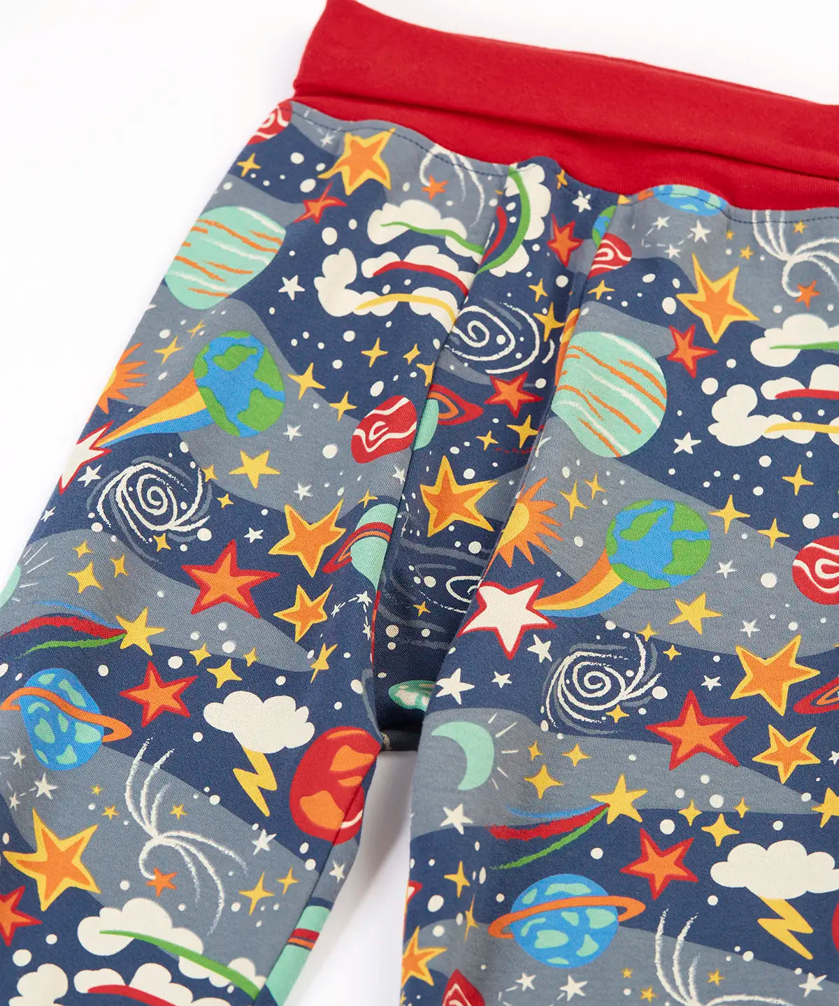 Frugi GOTS organic cotton parsnip pants in navy with outer space themed prints with a red fold up waist band for extender wear