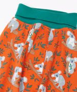 Frugi GOTS organic cotton parsnip pants in orange with a repeating koala  print and a teal elasticated waistband for extender wear