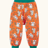Frugi parsnip pants in salamander orange with an all over koala cuddles print and green waist and leg cuffs.