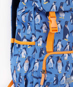 A close up of the Frugi kids trail blazing backpack in penguin waddle. Showing orange buckle for the flip top  and bottle holder detail