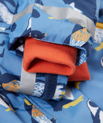 A close up of the Frugi kids snow and ski coat in penguin waddle showing the orange storm cuff detail and reflective strips
