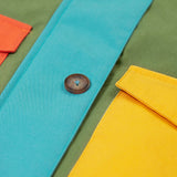 A close up of the Frugi khaki penhale colourblock parka showing the button fastener and pocket detail on organic cotton fabric