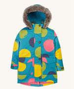 Frugi kids penhale super spot parka- A long length light blue thick coat with a big coloured circles design. Features a blue fleece inner and furry hood for warmth, full length button decoration and 2 side pockets on organic cotton fabric