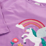 Close up of the front of the Close up of the white pegasus applique with rainbow and flowers details on the Frugi organic cotton periwinkle purple caris pegasus child's top. 