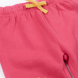 A close up of the yellow coloured waist tie on the Frugi rose pink coloured flower and mushroom crawlers kids joggers.