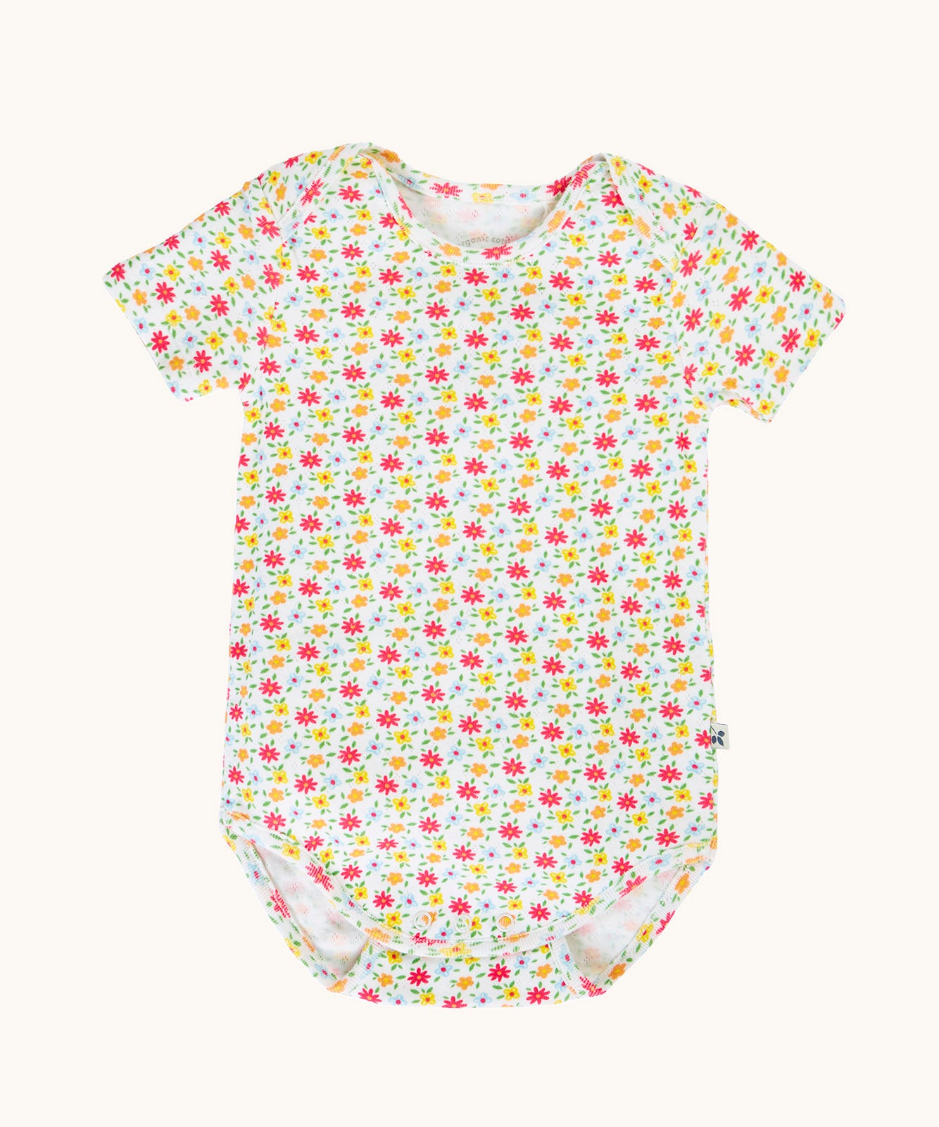 The all over floral ditsy print baby vest from the Frugi Pointelle short sleeved baby vest 2 Pack, one with a Ditsy Floral all over print the other had a pink and white stripe design.