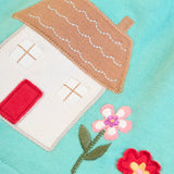 Frugi GOTS 100% organic cotton pinafore dress outfit showing a close up of the Highland cottage applique on the hem