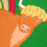 Frugi GOTS 100% organic cotton green pinafore dress outfit showing a close up of the highland cow appliqué
