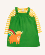 Frugi Pippa palm green pinafore dress outfit with highland cow applique and yellow breton striped long sleeved body. The green dress has a highland cow and rainbow applique detail on the front