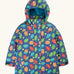 Frugi children's playtime waterproof coat with a multi-coloured acorn tumble print on a navy background.