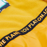 A close up of the yellow fleece inner on the Frugi playtime magic stars coat