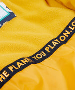 A close up of the yellow fleece inner on the Frugi playtime magic stars coat