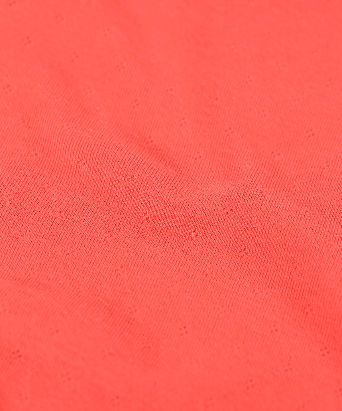Frugi long sleeve top in rhubarb pink organic cotton showing close up of the pointelle texture
