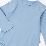 Frugi pointelle long sleeved baby body in winter sky blue with popper closure on the shoulders. 