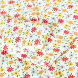 A close up of the fold over mitts on the Frugi Pointelle Organic Cotton footed Babygrow with an all over Ditsy Floral print.