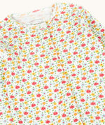 A close up of the front of the Frugi Pointelle Organic Cotton footed Babygrow with an all over Ditsy Floral print.