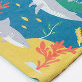 A close up of Frugi Iori Printed T-Shirt in Spring Mint's colourful Sea Life Scene which includes whales, sharks and other smaller fish and coral. 