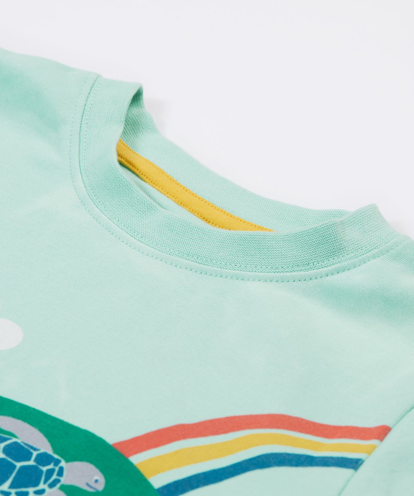 A close up of Frugi Iori Printed T-Shirt in Spring Mint's embroidered collar.