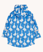 The back of a Frugi cobalt blue coloured rain jacket with white all over goose print. The jacket has reflective strips around the arms.