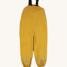 The Frugi children's waterproof Puddle buster trousers with elasticated arm straps, in bright Bumble Bee Yellow.