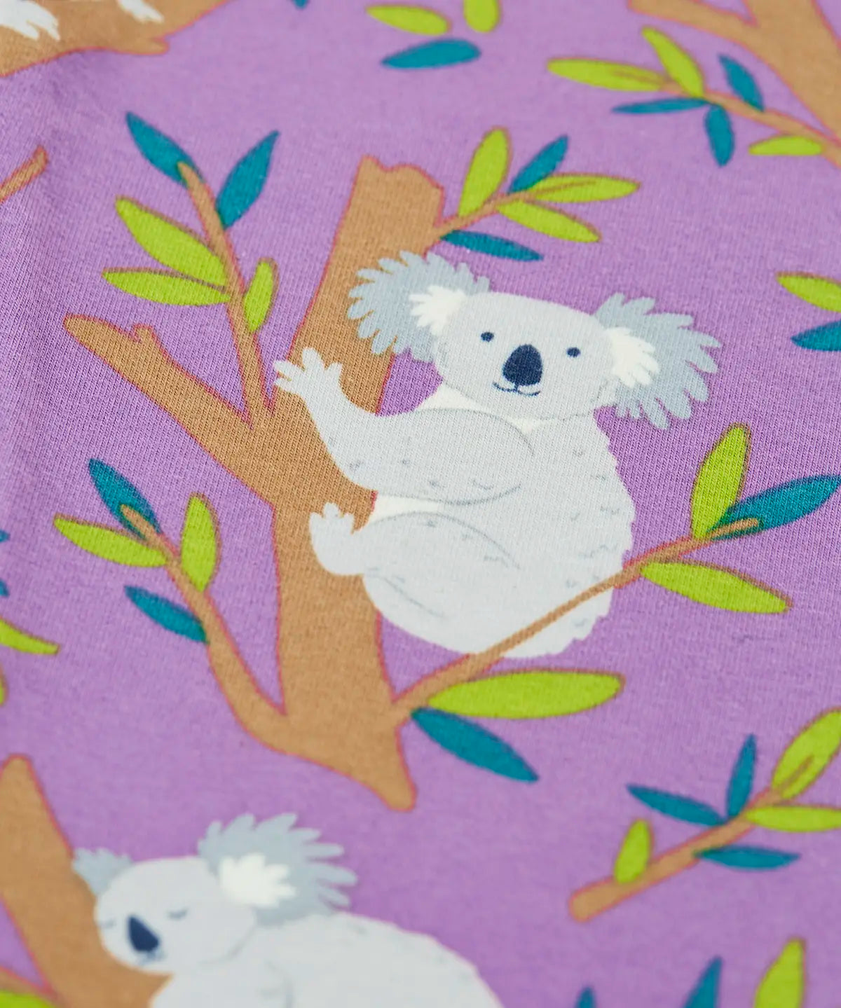 Close up of the print on the Frugi libby purple organic cotton leggings with an all over koala cuddles print.