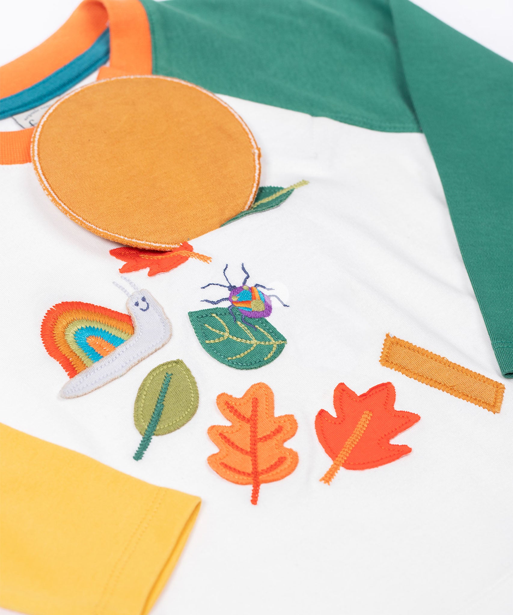 Frugi organic cotton Alfie interactive long sleeved top. The interactive element is a liftable circle that forms the head of the magnifying glass.
