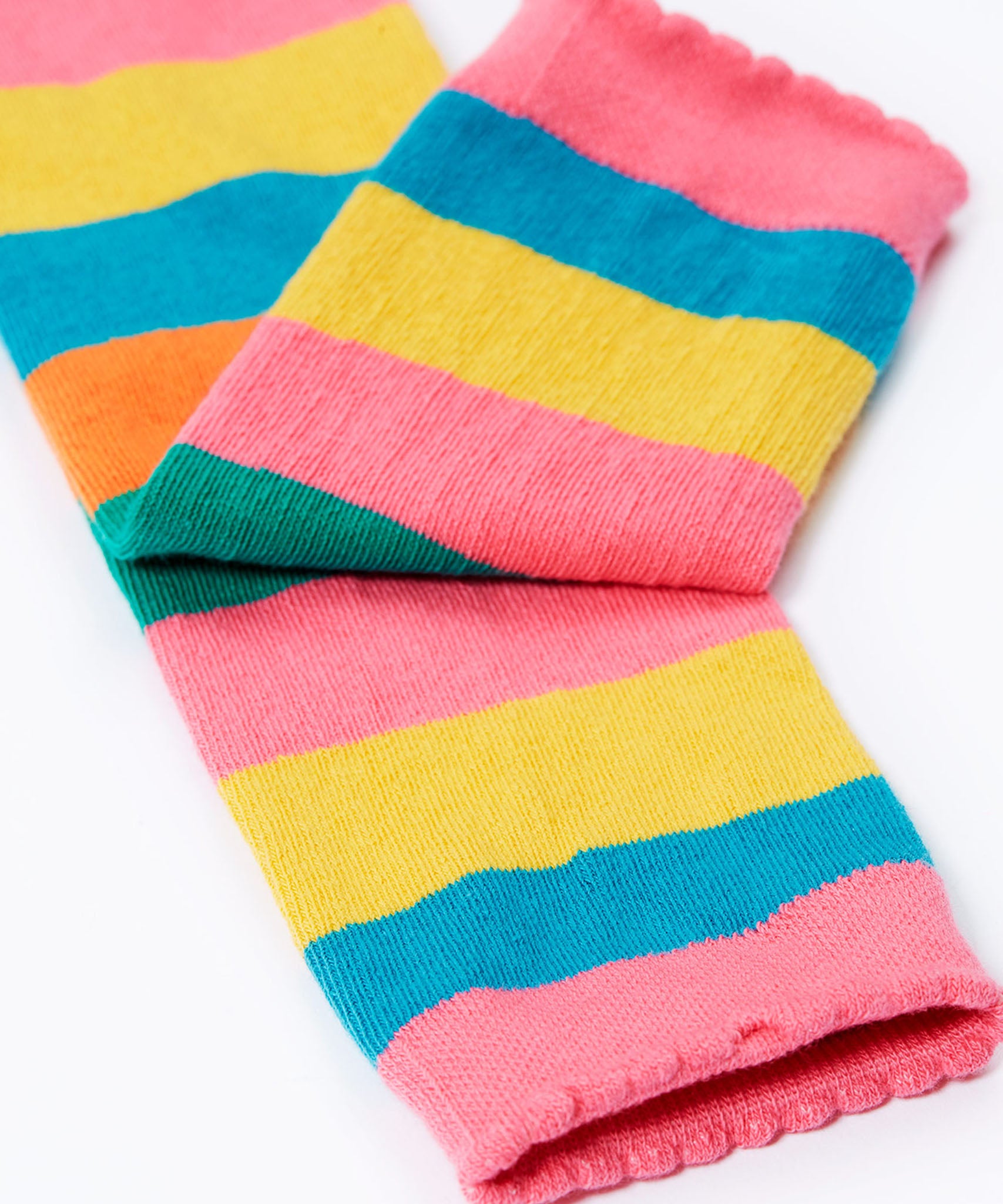 A close of of the pink coloured cuffs on the Frugi rainbow bee design organic cotton leggings footless tights.