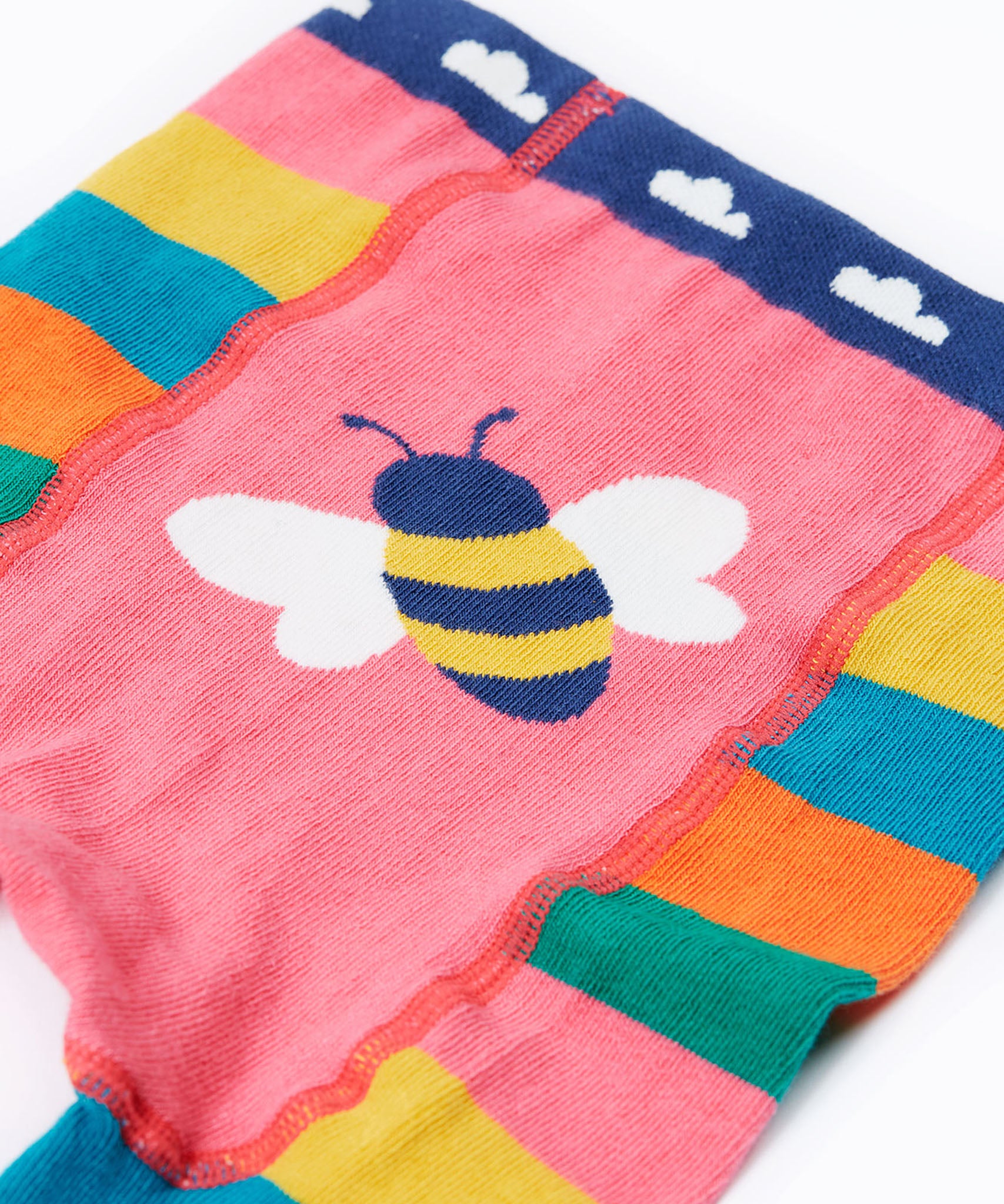 A close up of the bee on the behind of the Frugi rainbow bee design organic cotton leggings footless tights.