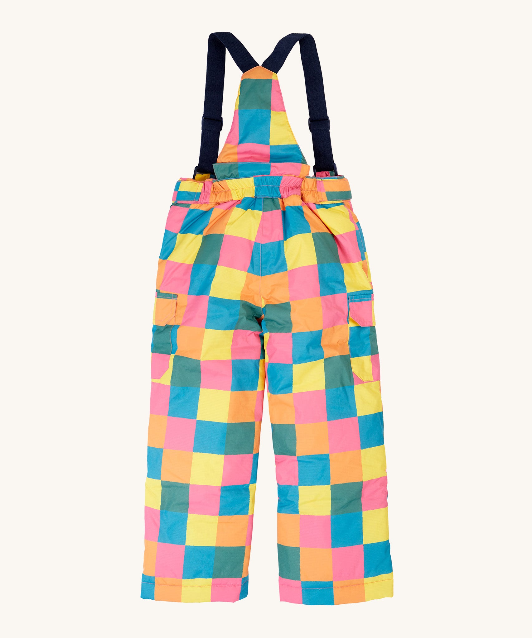 The back of the Frugi kids snow and ski salopettes in rainbow check. showing the elasticated waist band detail on brigh tchecked recycled polyester fabric