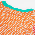 A close up of Frugi Estella Shirt, with a Rainbow Hotchpotch print, featuring orange patterns and a mint collar.
