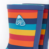 A close up of the top of the Frugi kids puddle buster wellington boots. Showing the the navy trim and rainbow inspired coloured stripes print detail on natural rubber material. Features a navy  triangular brand patch on the outside of the boot. 