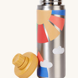 Frugi kids Insulated bottle in rainbow sun. A stainless steel bottle with prints of a yellow sun and rainbow coloured rays. Features a yellow cap with a loop that can be screwed on and off the bottle