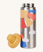 Frugi kids Insulated bottle in rainbow sun. A stainless steel bottle with prints of a yellow sun and rainbow coloured rays. Features a yellow cap with a loop that can be screwed on and off the bottle