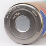 A close up of the Frugi kids Insulated bottle in rainbow sun. Showing the underneath the stainless steel bottle where a name can be written on 