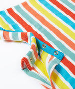 A close up of Frugi Dune Romper in Sea Rainbow Stripe print, featuring popper fastenings.