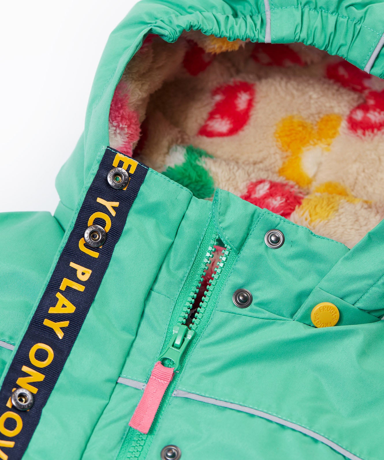 A close up of the Frugi kids 3 in 1 rambler coat in dragon/mushroom showing the zip detail and mushroom fleece liner inner on the hood