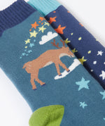 A close up of the reindeer on the Frugi Festive Reindeer Great Organic Cotton Grippy Socks for Kids 2 Pack. These socks have green coloured grippy stars on the soles. These socks are part of a wide range of organic cotton clothing for children available here at Babipur. 