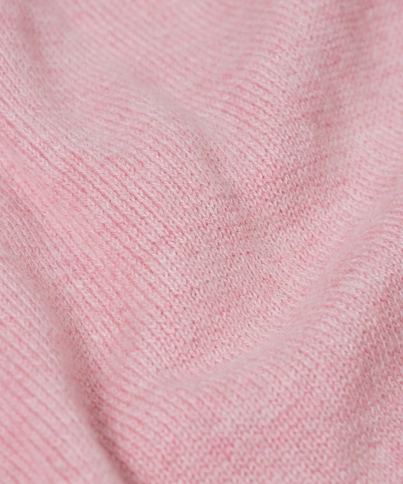A close up of the Frugi kids remi knitted romper in pink marl /flowers showing the soft knit detail