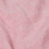 A close up of the Frugi kids remi knitted romper in pink marl /flowers showing the soft knit detail