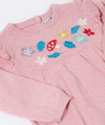 A close up of the Frugi kids remi knitted romper in pink marl /flowers showing the woodland inspired embroidery detail.