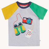 Frugi raglan t-shirt in a grey marl colour with one green and one yellow sleeve and an adventure themed applique design on the front featuring a pair of green binoculars, camera and a wild card compass. 