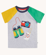 Frugi raglan t-shirt in a grey marl colour with one green and one yellow sleeve and an adventure themed applique design on the front featuring a pair of green binoculars, camera and a wild card compass. 