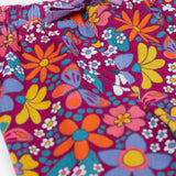 A close up of the purple waist tie on the Frugi Retro Floral print Nieva Cotton Corduroy Trousers. A purple coloured corduroy with a colourful all over floral print. These trousers are part of a wide range of organic cotton clothing for children available here at Babipur.